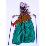 A 20th century Indonesian wooden puppet, with carved and decoratively painted head,