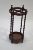 An early 20th century oak round stick stand, with barley twist supports,