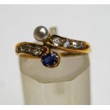 A late Victorian sapphire, diamond and pearl 18 carat gold cross over ring, Birmingham 1889,