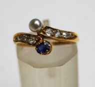 A late Victorian sapphire, diamond and pearl 18 carat gold cross over ring, Birmingham 1889,