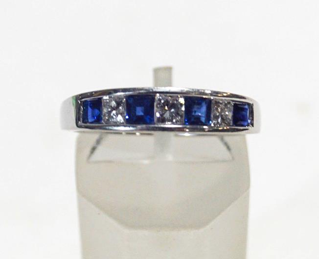 A modern white gold, sapphire and diamond half-eternity ring,