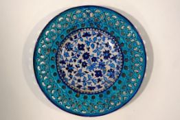 A 19th century Isnik pottery plate, the central panel with traditional flower design,