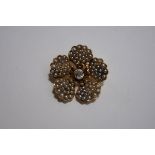 A late Victorian seed pearl and diamond flower head brooch pendant, unmarked,