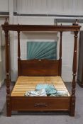A Victorian style mahogany four poster bed, with patterned and duck egg blue drapes,