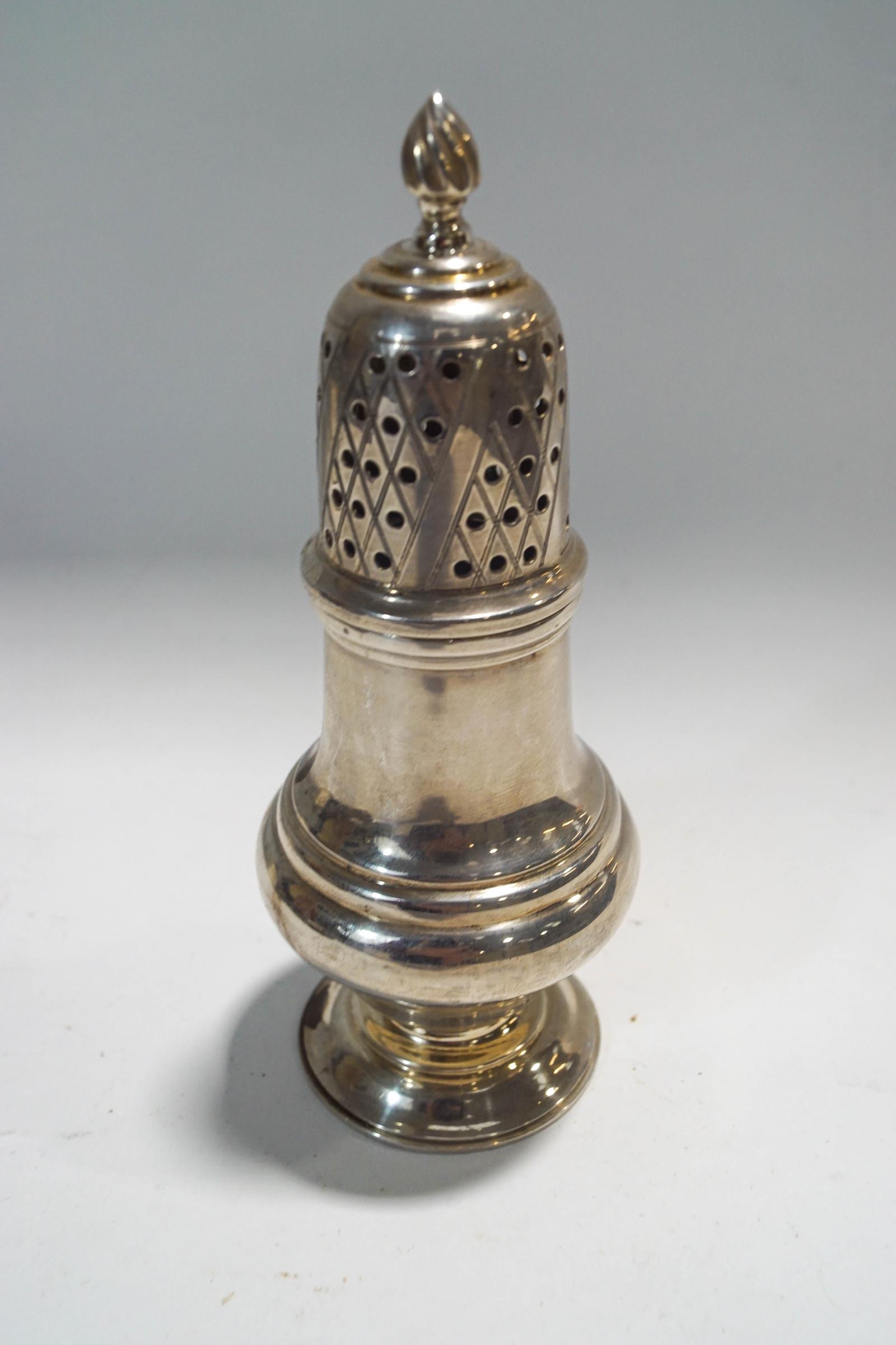 A silver vase shaped sugar caster, the pierced cover with a baluster finial,