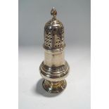 A silver vase shaped sugar caster, the pierced cover with a baluster finial,