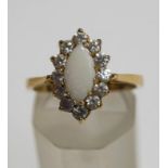 A 9 carat gold opal and cubic zirconia cluster ring, finger size O1/2, 3.