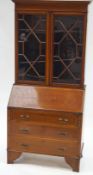 A 19th century mahogany bureau bookcase with two glazed doors above a fall front,