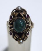A cabochon emerald set ring, with red stone and seed pearl points, probably Austro Hungarian,