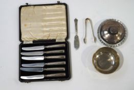 A small silver bowl, a cased set of silver handled butter knives, a pair of silver sugar nips,