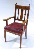 An Arts & Crafts oak elbow chair, designed in the manner of Charles Voysey,