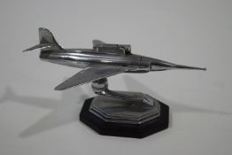 A chrome 'Gala-Sonic' table lighter, modelled as an aircraft, on an octagonal base,
