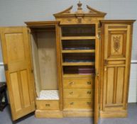 A Maple & Co triple oak wardrobe, with carved classical motifs and detail,