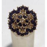 A sapphire and illusion set diamond 9 carat gold cluster ring, finger size N, 6.