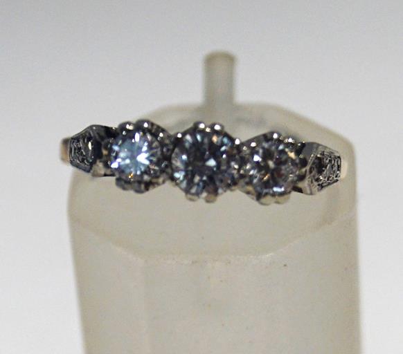 A diamond three stone ring, the round brilliants approximately 0.