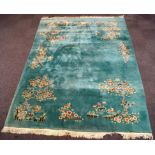 A large modern Chinese carpet with flowers and figures, on a duck egg blue ground,