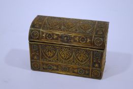 A domed top brass stationery box, with all over stylised scroll and plant decoration in relief,