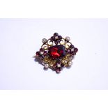 A seed pearl and garnet brooch, circa 1900,