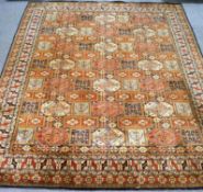 A large Middle Eastern machine woven carpet, with geometric design ,