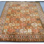 A large Middle Eastern machine woven carpet, with geometric design ,