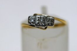 A diamond three stone ring, the single-cut stones approximately 0.