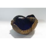 Taxidermy: an armadillo skin basket with a blue velvet lining