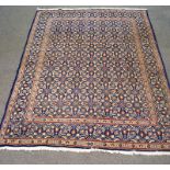 A large modern carpet with Persian style decoration on a blue ground,