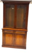 A Victorian mahogany display cabinet with two glazed doors above two frieze drawers above two