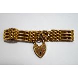 An Edwardian four bar gate bracelet, stamped '9ct', with textured links to a padlock clasp,