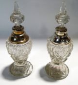 A pair of cut glass and silver mounted scent bottles with stoppers, London 1923,