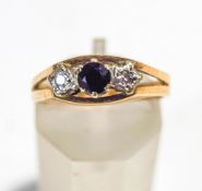 A diamond and sapphire three stone 9 carat gold ring, the small brilliant cuts illusion set,