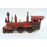 An early 20th Century model of a steam train with turned and painted body on cast iron wheels and