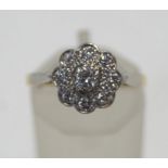 An early 20th century gold and diamond daisy cluster ring,