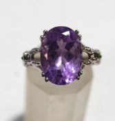An amethyst and gem set dress ring, the white mount stamped '9K', finger size N, 4.