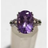 An amethyst and gem set dress ring, the white mount stamped '9K', finger size N, 4.