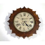 A late 19th/early 20th Century oak cased wall clock, the painted dial signed J.W.