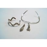 A torque necklace; a bangle; and a pair of earrings;