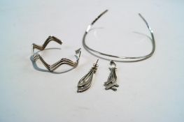 A torque necklace; a bangle; and a pair of earrings;