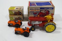 A Tricky Tommy battery operated tin plate and plastic tractor in original box,