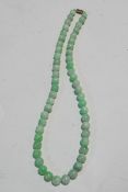 A Jade bead necklace, the 53 round beads slightly graduated, approximately 11mm to 8.
