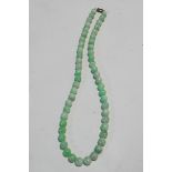 A Jade bead necklace, the 53 round beads slightly graduated, approximately 11mm to 8.