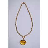 A citrine three sided rotating seal; on a chain, 46 cm long, 31 g gross,