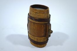An oak barrel flask with leather straps and glass ends,