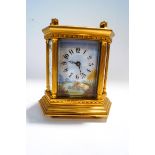 A 20th Century French brass carriage clock, inset with six enamel panels,