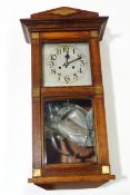 An early 20th century oak cased wall clock, with square silvered dial,
