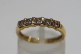 A modern 18ct gold and princess diamond half-eternity ring, the five stones approximately 0.
