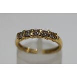 A modern 18ct gold and princess diamond half-eternity ring, the five stones approximately 0.