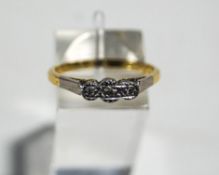 An illusion set three stone diamond ring, stamped '18ct', finger size Q,3.