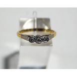 An illusion set three stone diamond ring, stamped '18ct', finger size Q,3.