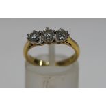 A three stone diamond, 18ct gold ring, the brilliant cuts totalling approximately 0.